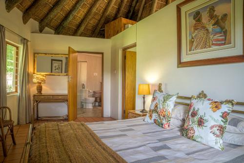 a bedroom with a bed and a bathroom at Lemberg Wine Estate in Tulbagh