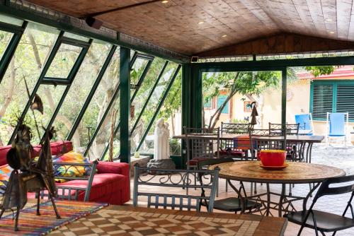a conservatory with tables and chairs and windows at B&B La Nave in Naples
