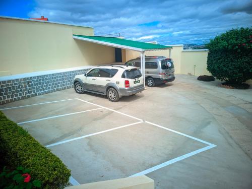 a car parked in a parking lot in front of a building at Sara Chambre d'hôtes in Antananarivo