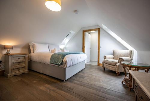 a bedroom with a bed and a chair at Avoca Lodge in Fort William