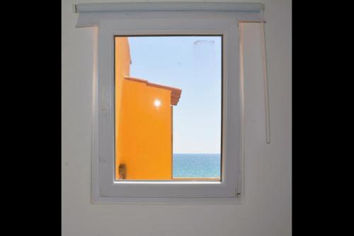an open window with a view of the ocean at Blife Faro Beach Hostel & Rooms in Faro