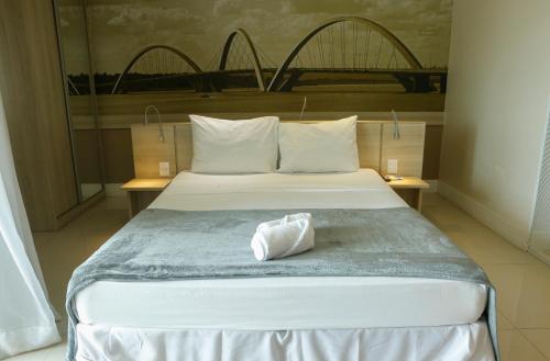 a hotel room with a bed with a towel on it at Flat no Brasília Lider, 14º Andar in Brasília