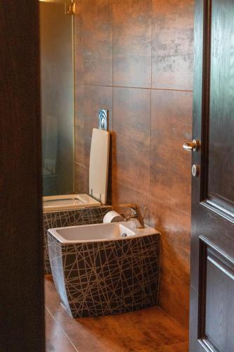 a bathroom with a sink and a mirror at Angoni Villa in Durrës