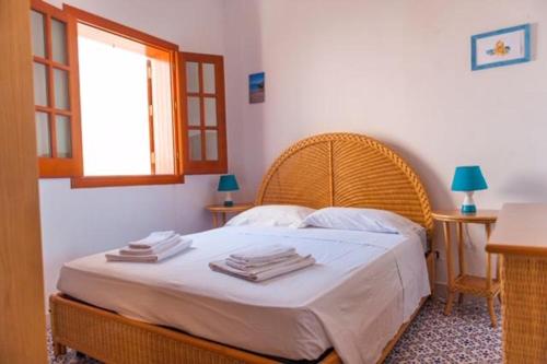 a bedroom with a bed with towels on it at Mare E Timo in Marettimo