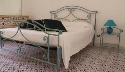 a bedroom with a bed with a metal frame at Mare E Timo in Marettimo