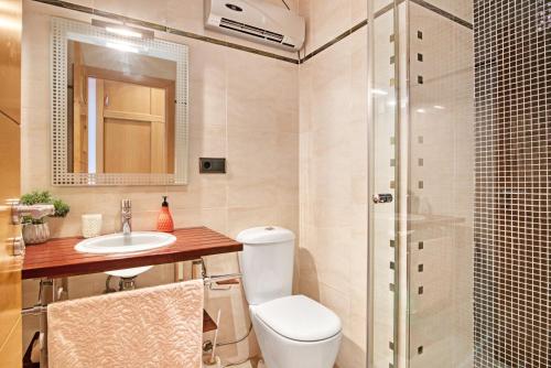 a bathroom with a toilet and a sink and a shower at Somni in Jávea