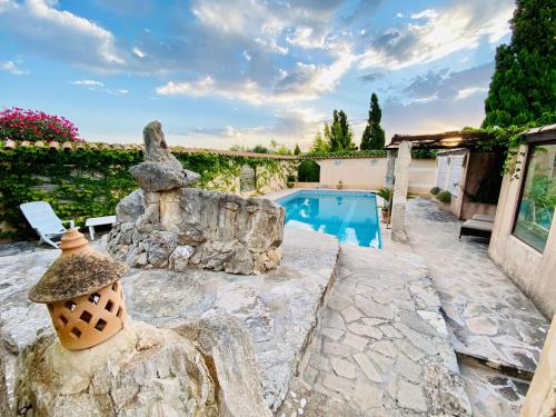 a backyard with a swimming pool and a stone wall at FincaOase-Can-Negre-Son-Macia-App-Petit in Son Macia