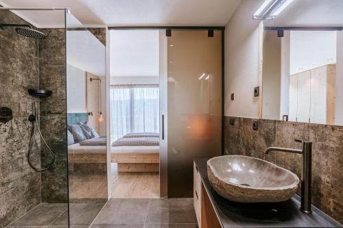 a bathroom with a sink and a shower at Chalets Hansleitner in Terento