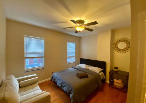 a bedroom with a bed and a ceiling fan at Historic Townhouse Oasis with En-suite Bathroom in Philadelphia