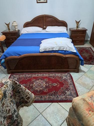 a bedroom with a bed with a blue comforter at b&b ventolina in Rivara