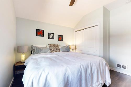 a white bedroom with a large white bed in it at Western Slope Retreat in Gunnison