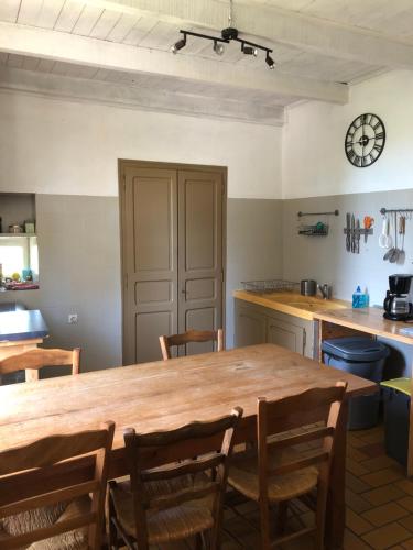 a kitchen with a large wooden table and chairs at Gîte des pins in Saint-Maurice-dʼIbie