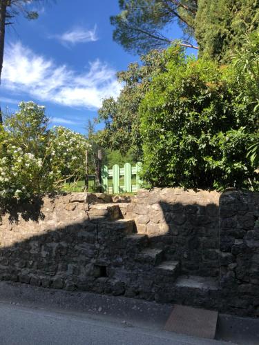 a shadow of a stone wall on the side of a road at Gîte des pins in Saint-Maurice-dʼIbie