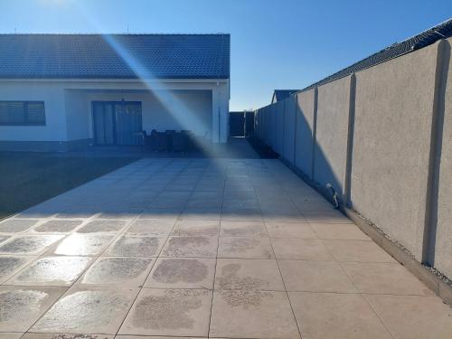 a fence with a tile floor next to a building at Villa Holiday Hevlín in Hevlín