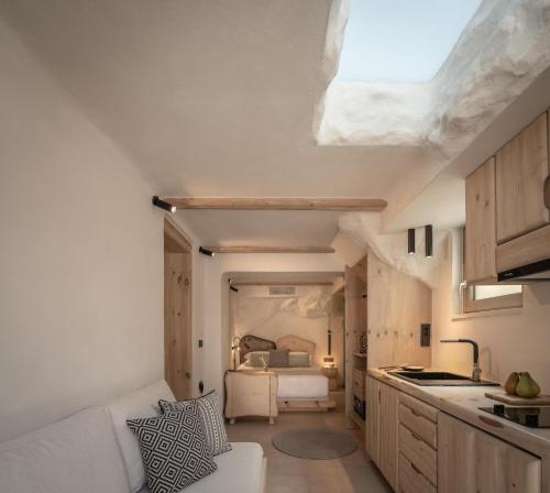 a kitchen and living room with a couch and a bed at Manili Boutique Suites & Villas in Archanes