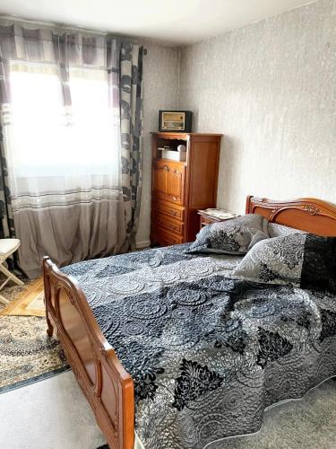 a bedroom with a bed and a window at Villa charmante à Élancourt avec jardin privé in Élancourt