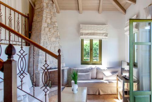 a living room with a couch and a window at Asplathia Villas in Spanokhórion