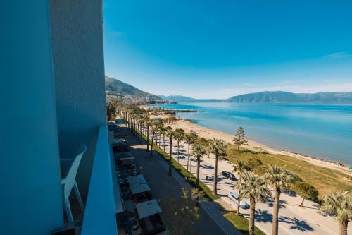 a view of a beach with palm trees and the ocean at DUKA Hotel in Vlorë