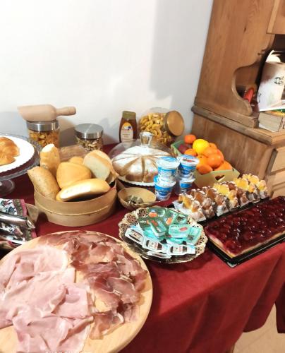 a table topped with lots of different types of food at Chalet - Margherita in Sappada