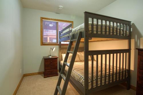 a bedroom with two bunk beds and a window at Marble Canyon in Fairmont Hot Springs