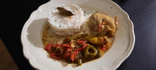 a plate of food with rice and vegetables on a table at Les Vagabonds du Mont in Chichilianne