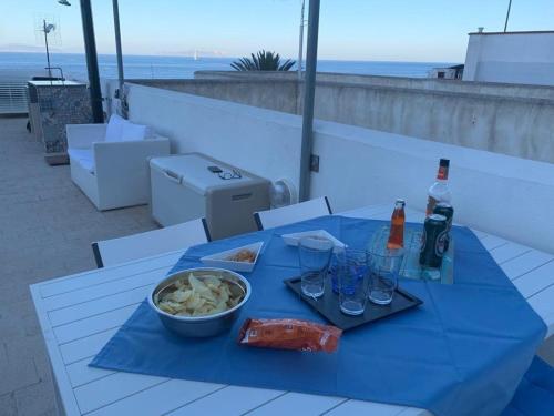 a blue table with a bowl of food and drinks at HIERA CASAVACANZE in Marettimo