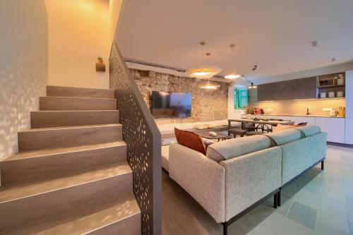 a living room with a staircase and a kitchen at Bastinica Platinum Ap 4 * * * * * in Krk