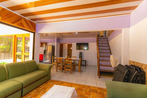 a living room with a couch and a table at Casa Almendro Playa Panamá in Panamá