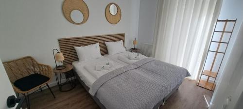 a bedroom with a bed and a mirror on the wall at Apartament "Przy Szlaku" - Ostoja Parku in Szklarska Poręba
