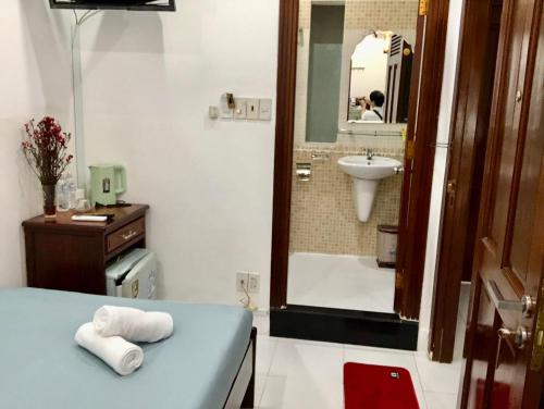 a bathroom with a sink and a bath tub at Saigon Cozy2 Hotel in Ho Chi Minh City