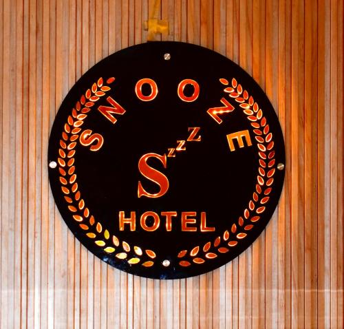 a clock on a wall that says s hotel at HOTEL SNOOZE in Jaipur