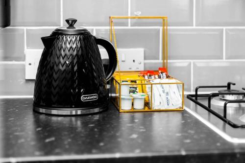 a black coffee pot sitting on a kitchen counter at Stylish Apartment - Cradley Heath - Pet Friendly - Parking - Netflix 2MH in Birmingham