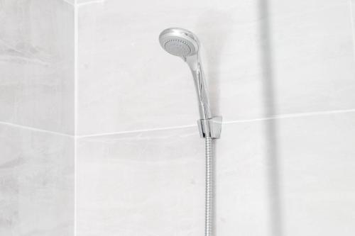 a shower head in the corner of a bathroom at Stylish Apartment - Cradley Heath - Pet Friendly - Parking - Netflix 2MH in Birmingham