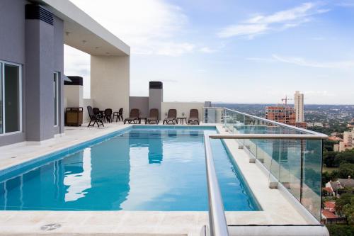 a swimming pool on the roof of a building at Asunción Rent Suites Santa Teresa in Asuncion