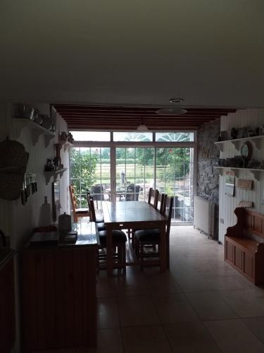 a dining room with a table and chairs in a kitchen at Willsgrove House in Athy