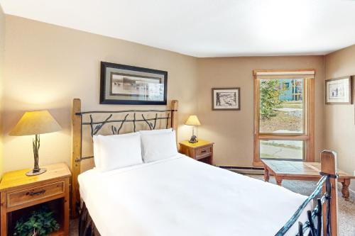 a bedroom with a large white bed and a window at Lodge at Steamboat B205 in Steamboat Springs