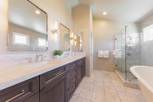 a bathroom with two sinks and a shower at SB-316 - Sunset Hacienda in Solana Beach