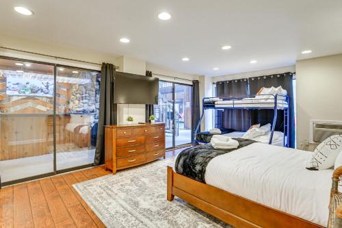 a bedroom with a bed and a dresser at Bloomfield Retreat with Indoor Pool and Tennis Court! in Bloomfield Hills