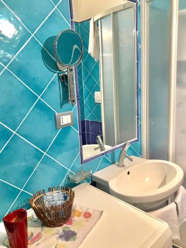 a bathroom with a sink and a toilet and a mirror at Le Case della Costa - Apartment Positano in Maiori