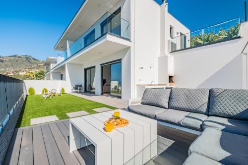 a living room with a couch and a table at Villa Fénix in Câmara de Lobos
