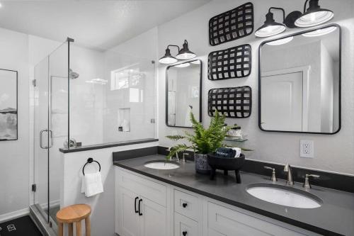 a bathroom with two sinks and two mirrors at Cherry Mountain, private home with great views in Crabapple