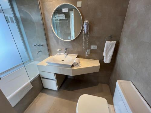 a bathroom with a sink and a mirror at Hotel Zentiva Pinamar in Pinamar
