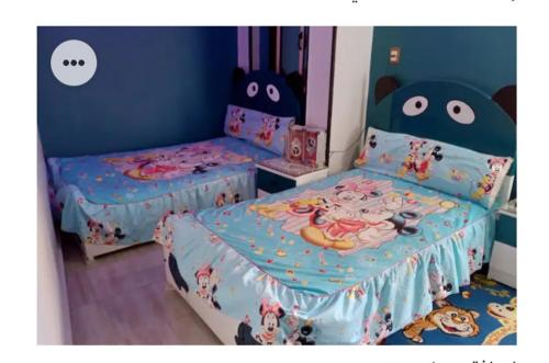 a bedroom with two beds with hello kitty sheets at Amira Hospitality House in Aswan