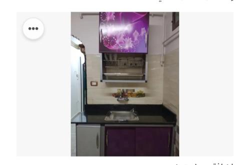 a kitchen with a sink and a purple painting on the wall at Amira Hospitality House in Aswan