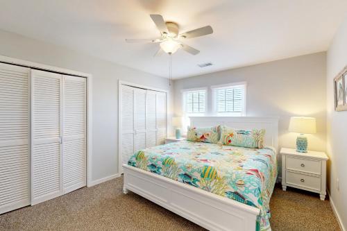 a bedroom with a bed and a ceiling fan at Whelk #22B-CAC in Buxton