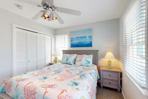 a bedroom with a bed and a ceiling fan at Whelk #22B-CAC in Buxton