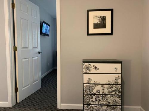 a hallway with a white door and a picture on the wall at Private Suite in Davison in Davison