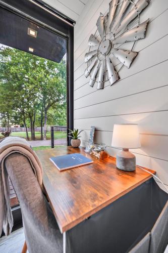 a table with a laptop on it in a room with a window at Bluebonnet Trail in Waco