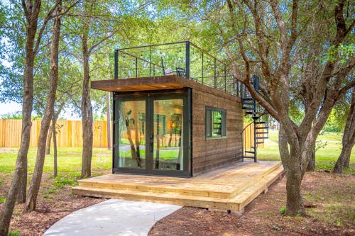 a tiny house in the middle of trees at Bluebonnet Trail in Waco