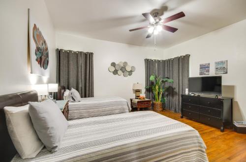 a bedroom with two beds and a ceiling fan at Updated Greenwood Cottage Apt Less Than 1 Mi to Dtwn! in Greenwood